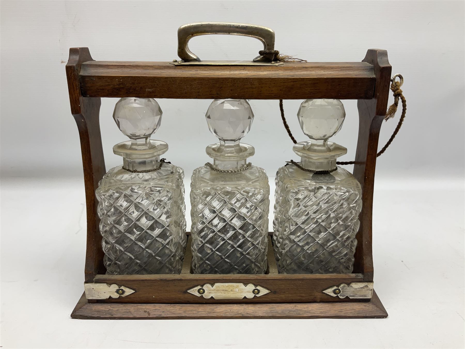 Edwardian oak tantalus with silver plated mounts with three square sided glass decanters - Image 8 of 8