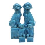 Two pairs of Chinese Foo dogs in blue glaze