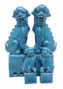 Two pairs of Chinese Foo dogs in blue glaze