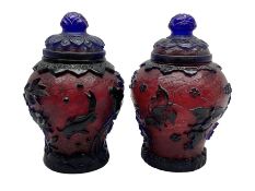 Two Chinese Peking glass baluster vases with covers