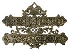 Bronzed cast metal numbered key rack of pierced and scrolled design