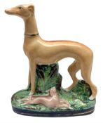 Staffordshire style figure of a greyhound beside a dead rabbit
