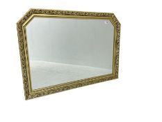 Gilt composition framed rectangular wall mirror with foliate mouldings and canted corners