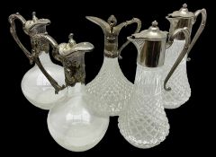 Collection of five silver-plate mounted glass claret wine jugs