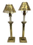 Two brass candlesticks modelled as Corinthian columns