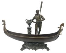 Bronzed and pewter figure group depicting a gentleman stood holding an oar behind his long boat besi