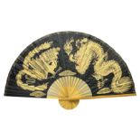 Chinese fan of large proportion decorated with gilt dragons on black ground