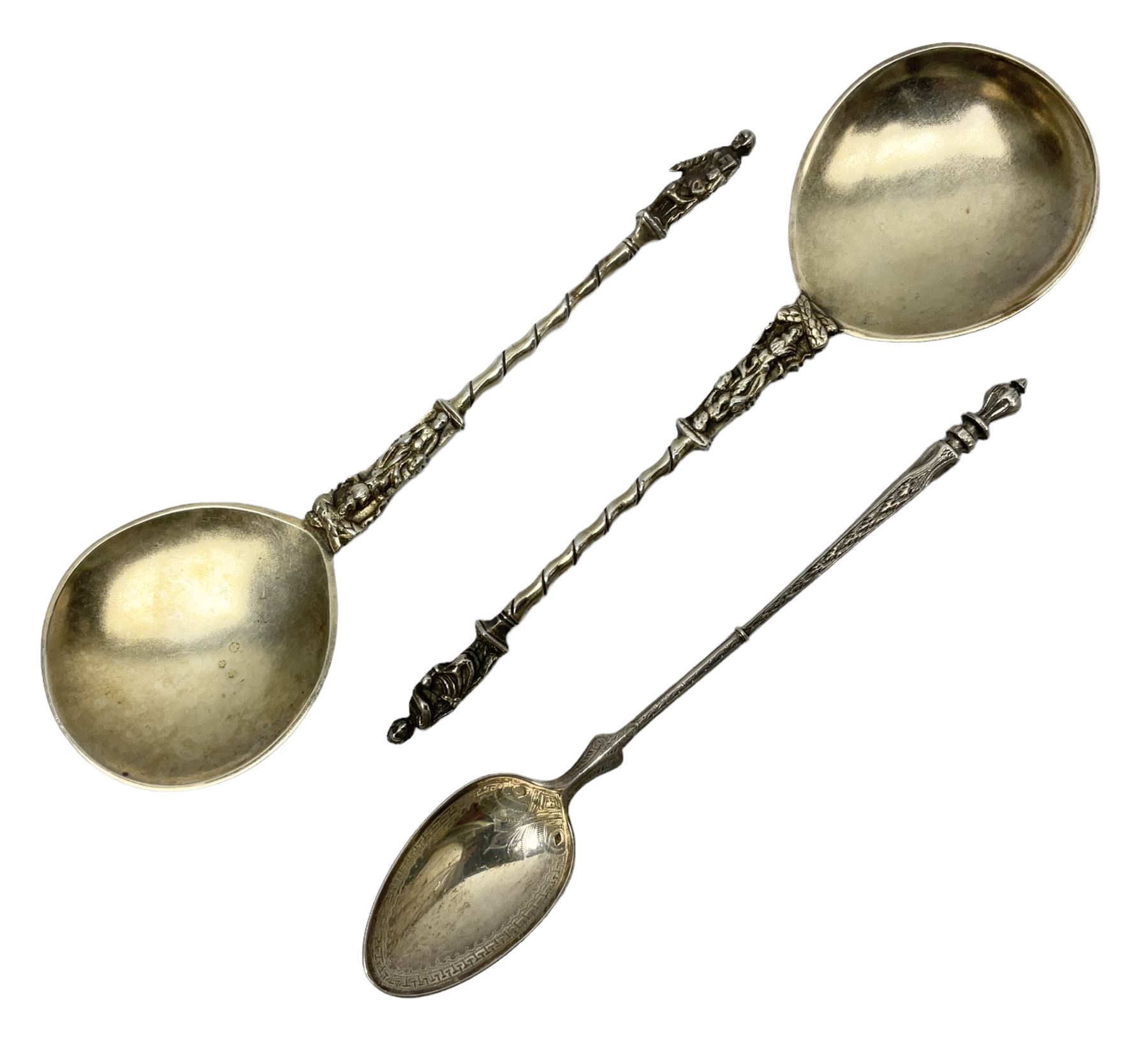 Silver spoon with elongated stem and engraved detail