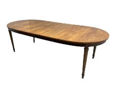 Mid-20th century walnut and elm oval extending dining table with two additional leaves