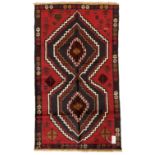 Baluchi red and blue ground rug decorated with two geometric lozenges and a repeating border