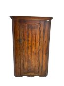 Late 19th century pine corner cabinet with shaped panelled door