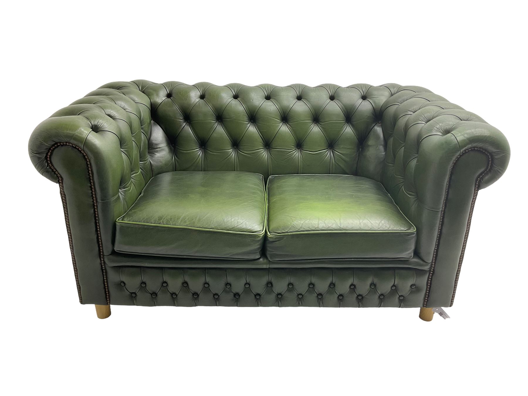 Chesterfield style two seat sofa upholstered in buttoned green leather with stud work