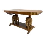Hardwood coffee table on carved elephant figure supports