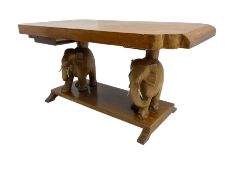 Hardwood coffee table on carved elephant figure supports