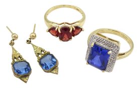 Gold three stone garnet ring and a gold synthetic blue stone dress ring