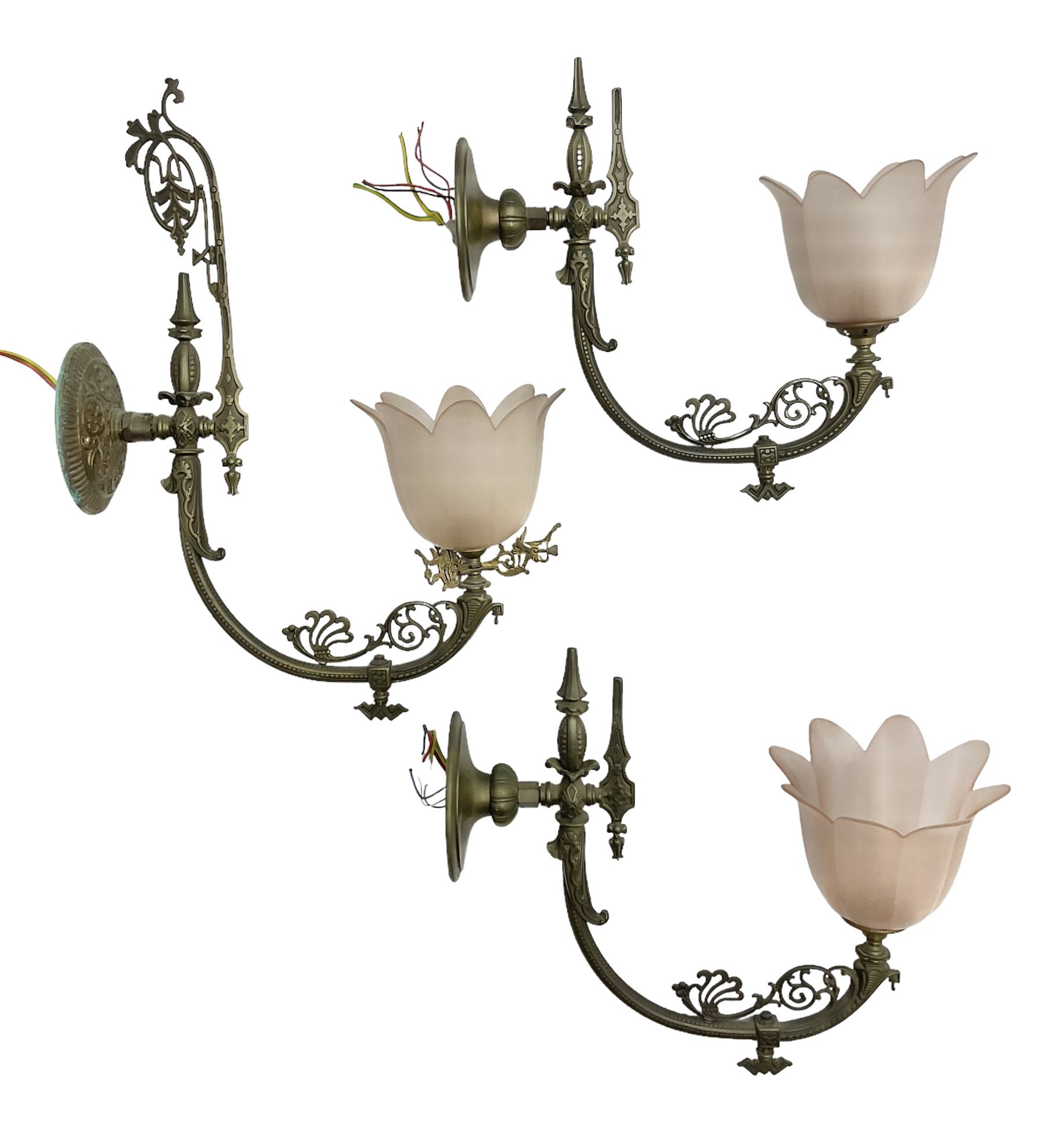 Set of three early 20th century brass wall lights with opaque pink glass shades in the form of flowe