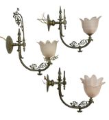 Set of three early 20th century brass wall lights with opaque pink glass shades in the form of flowe