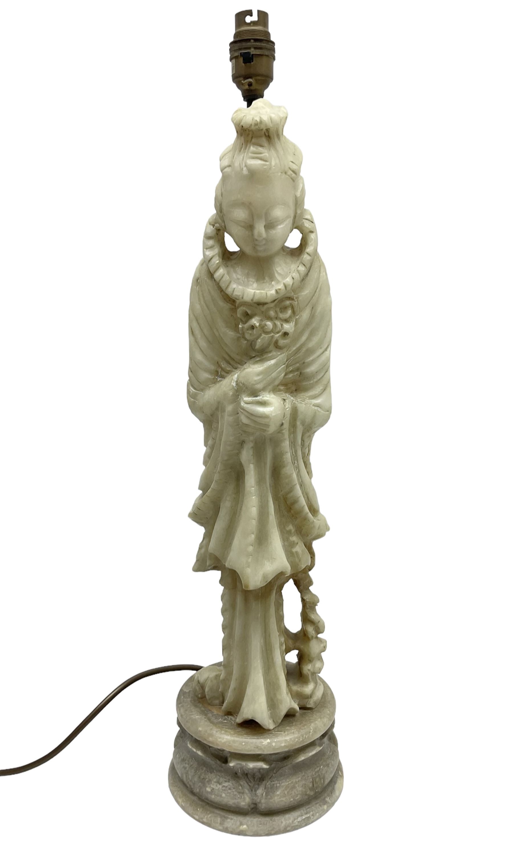 Carved soapstone lamp of Quan Yin on a lotus base