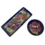 Moorcroft rectangular pin dish decorated in the Clematis pattern upon cobalt blue ground