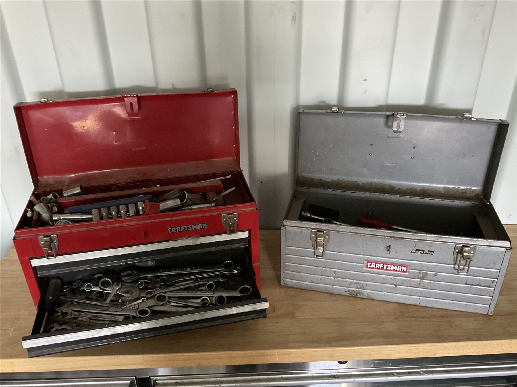 Two Craftsman toolboxes with tools such as sockets