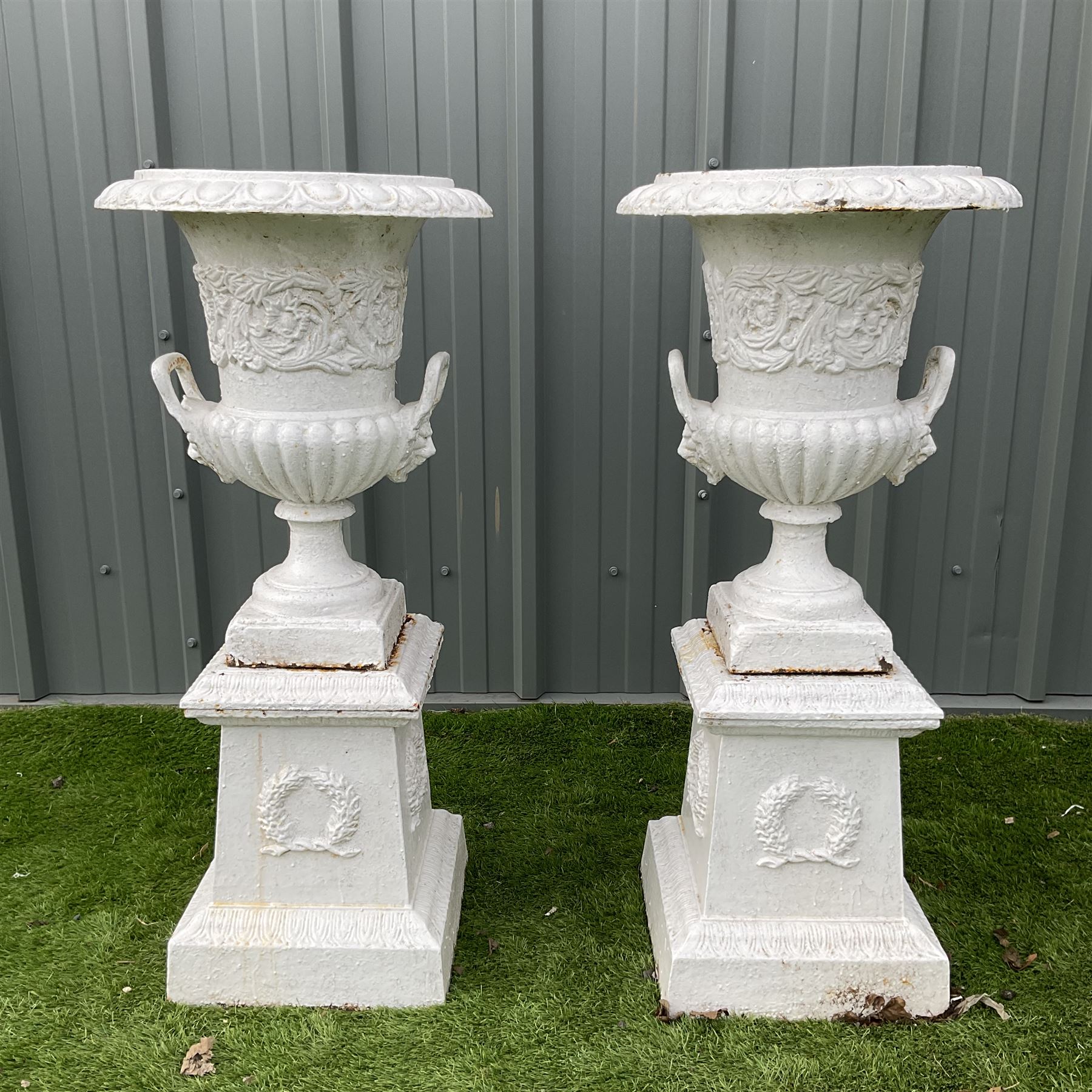 Pair of Victorian cast iron white painted urns on plinths - THIS LOT IS TO BE COLLECTED BY APPOINTME