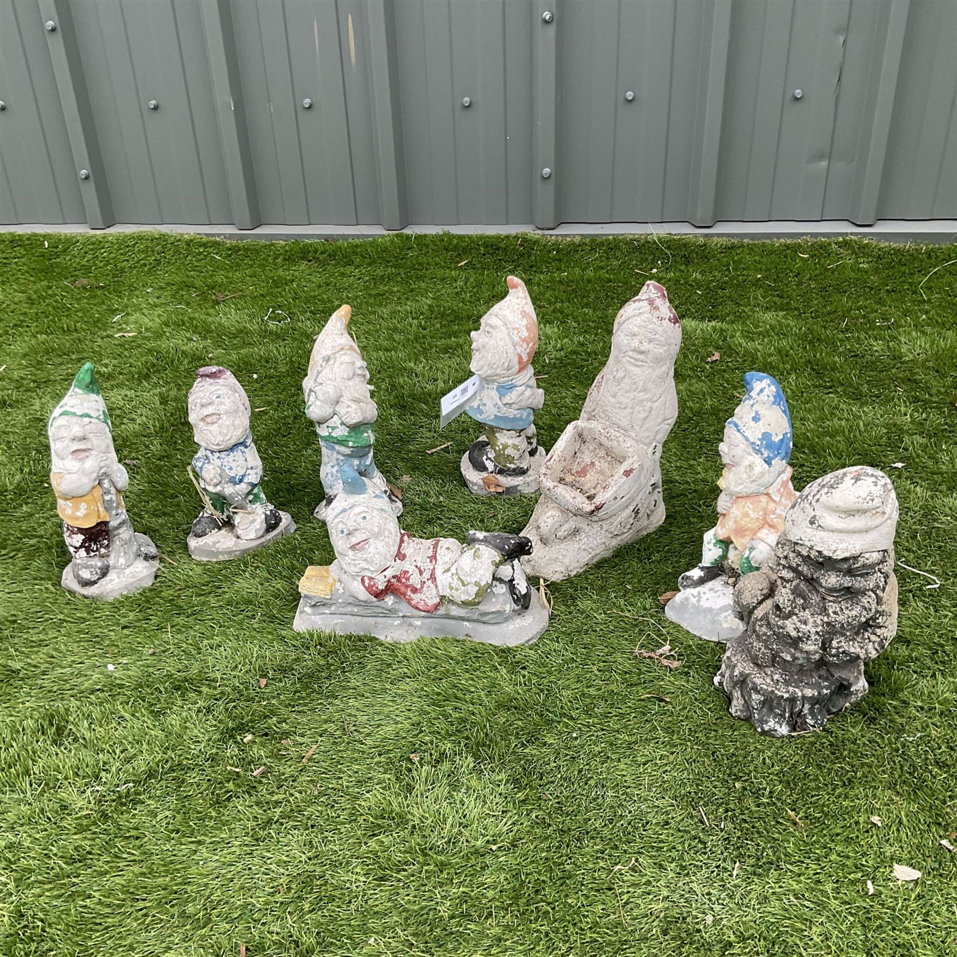 Eight cast stone miniature garden gnomes