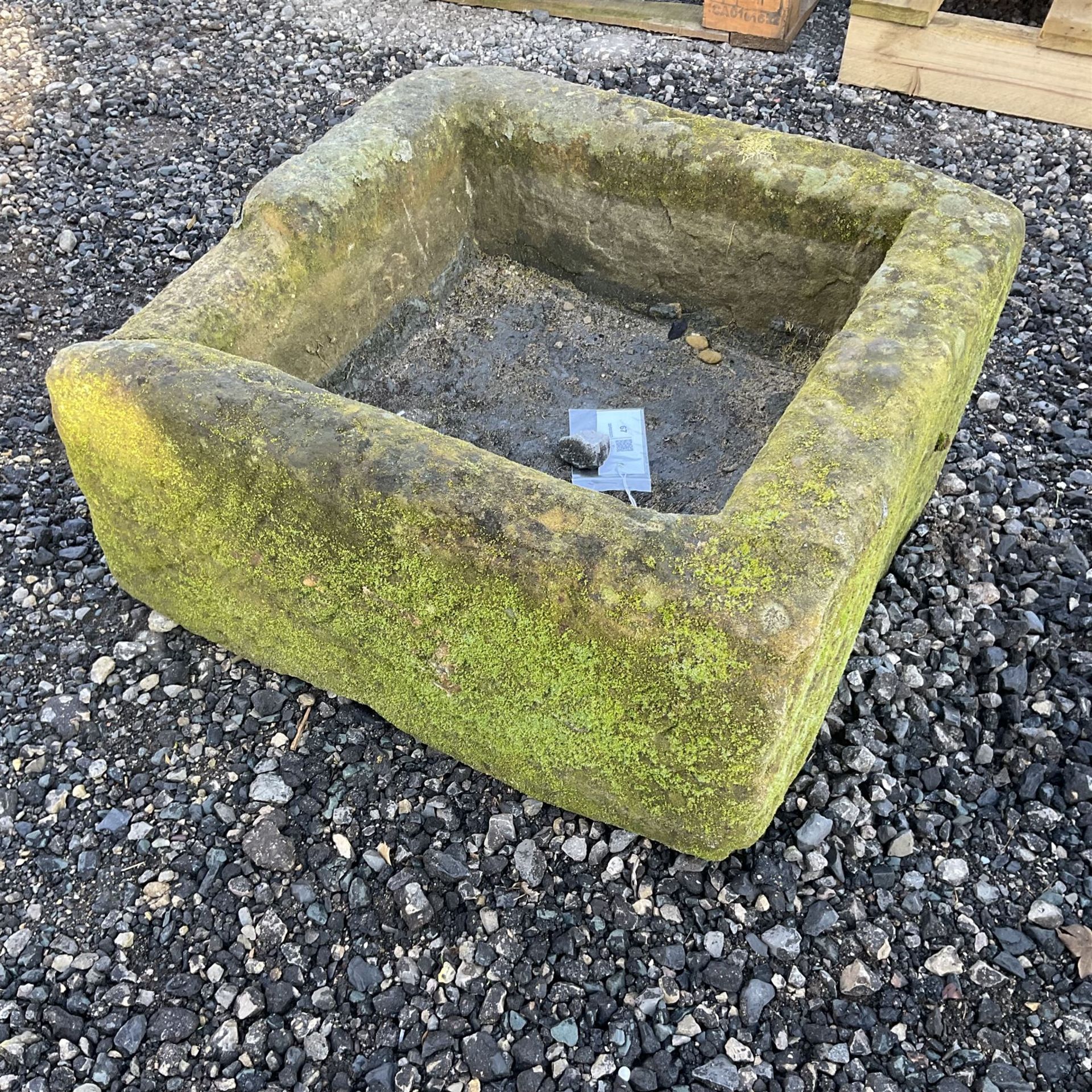 Small square shaped carved stone trough