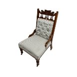 Late Victorian nursing chair upholstered in striped fabric