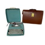 Blue Smith-Corona typewriter and leather bag