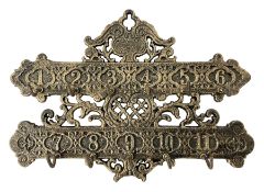 Bronzed cast metal numbered key rack of pierced and scrolled design