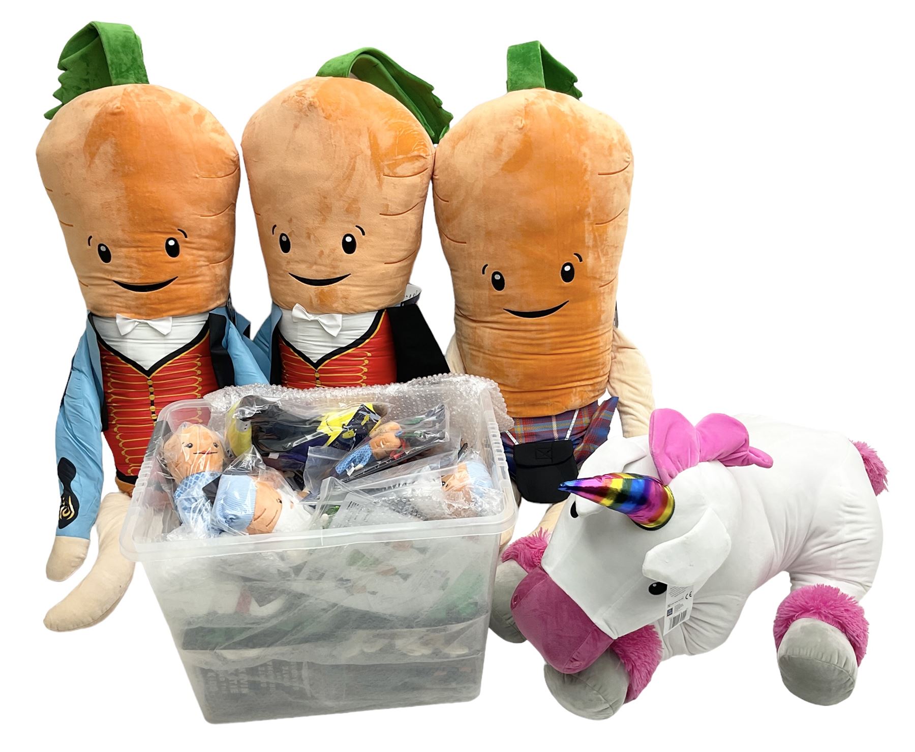 Three large ALDI Kevin carrots and giant unicorn stuffed toy together with quantity of smaller carro