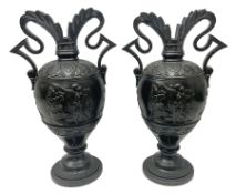 Pair of late 19th century continental black glazed urn shaped two-handled vases with classical style