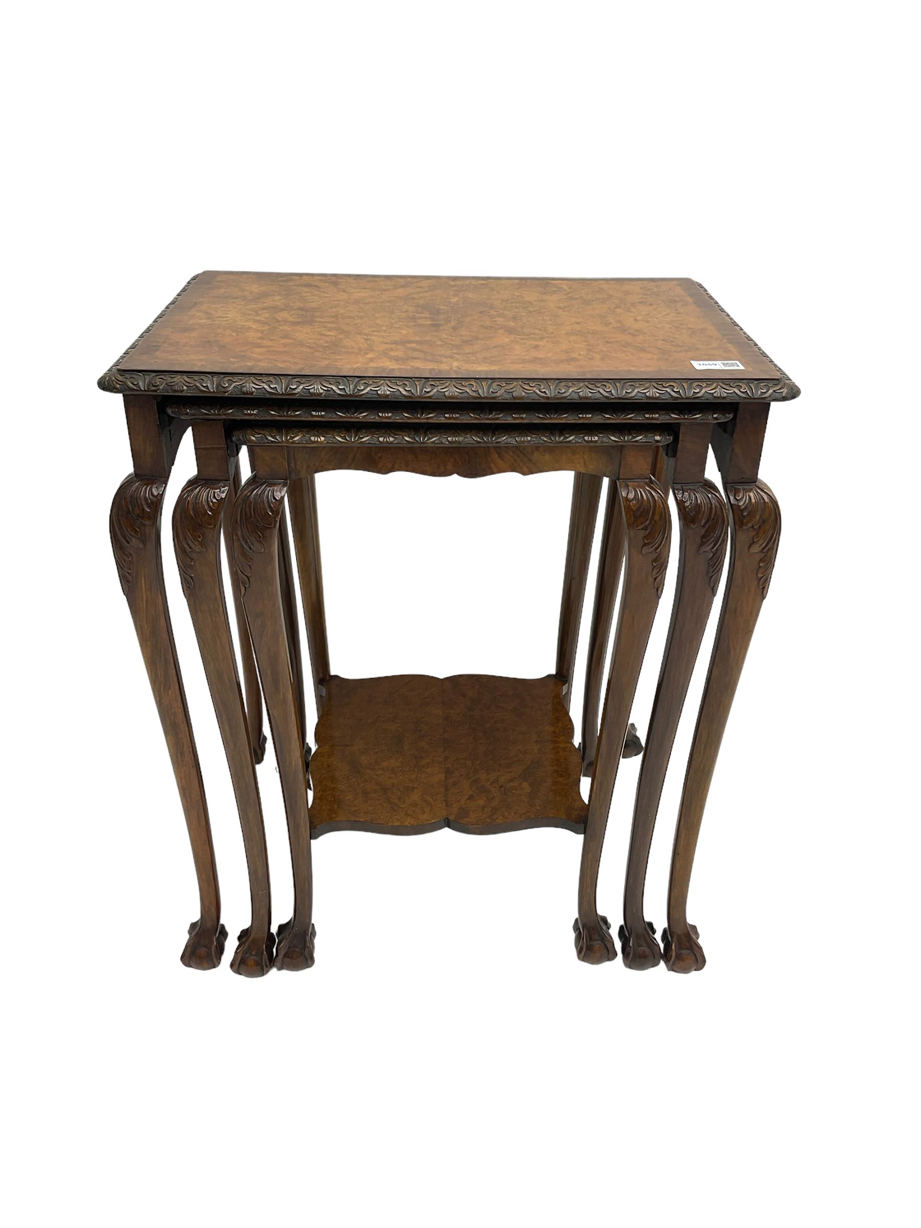 Mid-20th century figured walnut nest of three tables