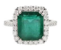 18ct white gold emerald and round brilliant cut diamond cluster ring