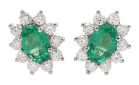 Pair of 18ct white gold oval emerald and round brilliant cut diamond cluster stud earrings