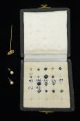 Loose vari-cut gemstones including blue and green sapphires