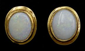 Pair of 9ct gold single stone oval opal stud earrings