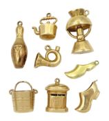 Seven 9ct gold charms including bucket