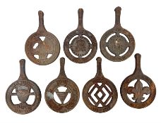 Seven late 20th century cast iron trivets