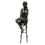 Art Deco style bronze modelled as a female figure seated upon a chair holding an apple