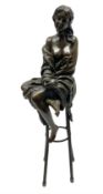 Art Deco style bronze modelled as a female figure seated upon a chair holding an apple