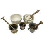 Group of pestle and mortars to include heavy bronze example with twin handles