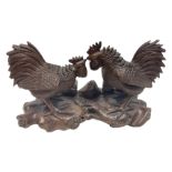 Pair of Japanese Meiji carved hardwood fighting cockerels