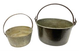 Two brass jam pans with cast iron handles