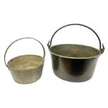 Two brass jam pans with cast iron handles