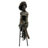 Art Deco style bronze modelled as a female figure seated cross legged upon a chair