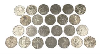 Twenty-four Queen Elizabeth II Great British commemorative fifty pence coins from circulation