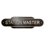 Cast iron Station Master wall plaque on a brown ground