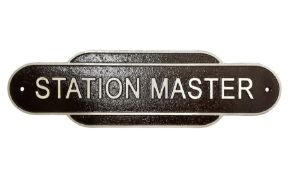 Cast iron Station Master wall plaque on a brown ground