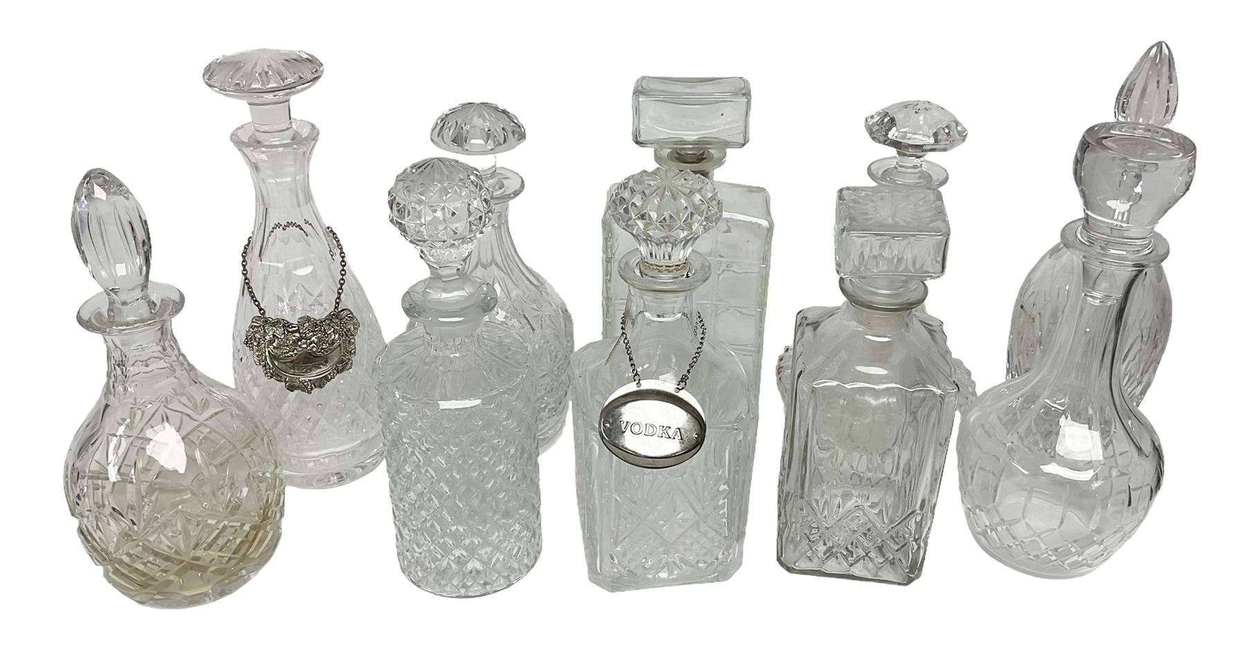 Ten decanters to include an I.W. Harper example of concave square form and two examples with tags
